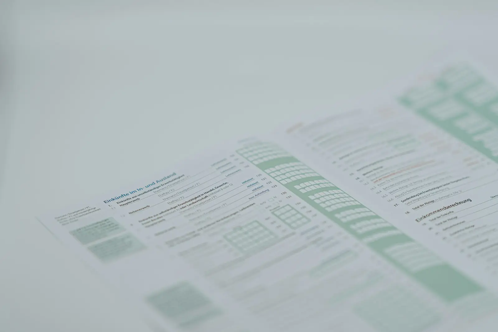 A close-up of a printed page laid out in dense columns and tables, softly out of focus